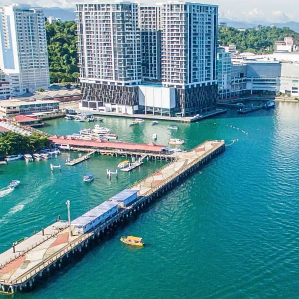 Aerial view of Jesselton Ferry Terminal in Kota Kinabalu, showing the piers, boats, and surrounding waterfront