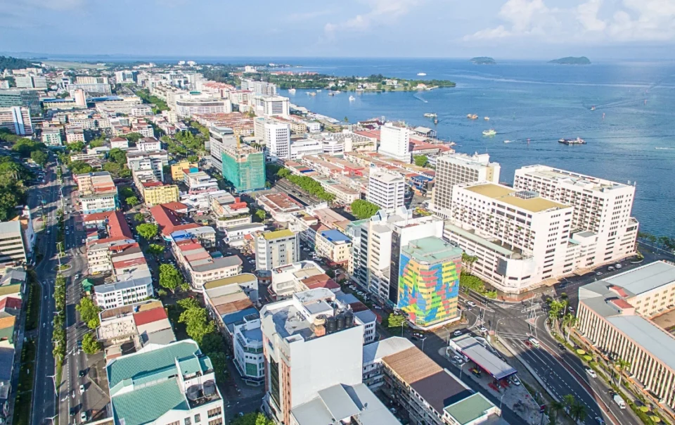 Sunny skies over the city of Kota Kinabalu. Featuring the city's buildings and sea