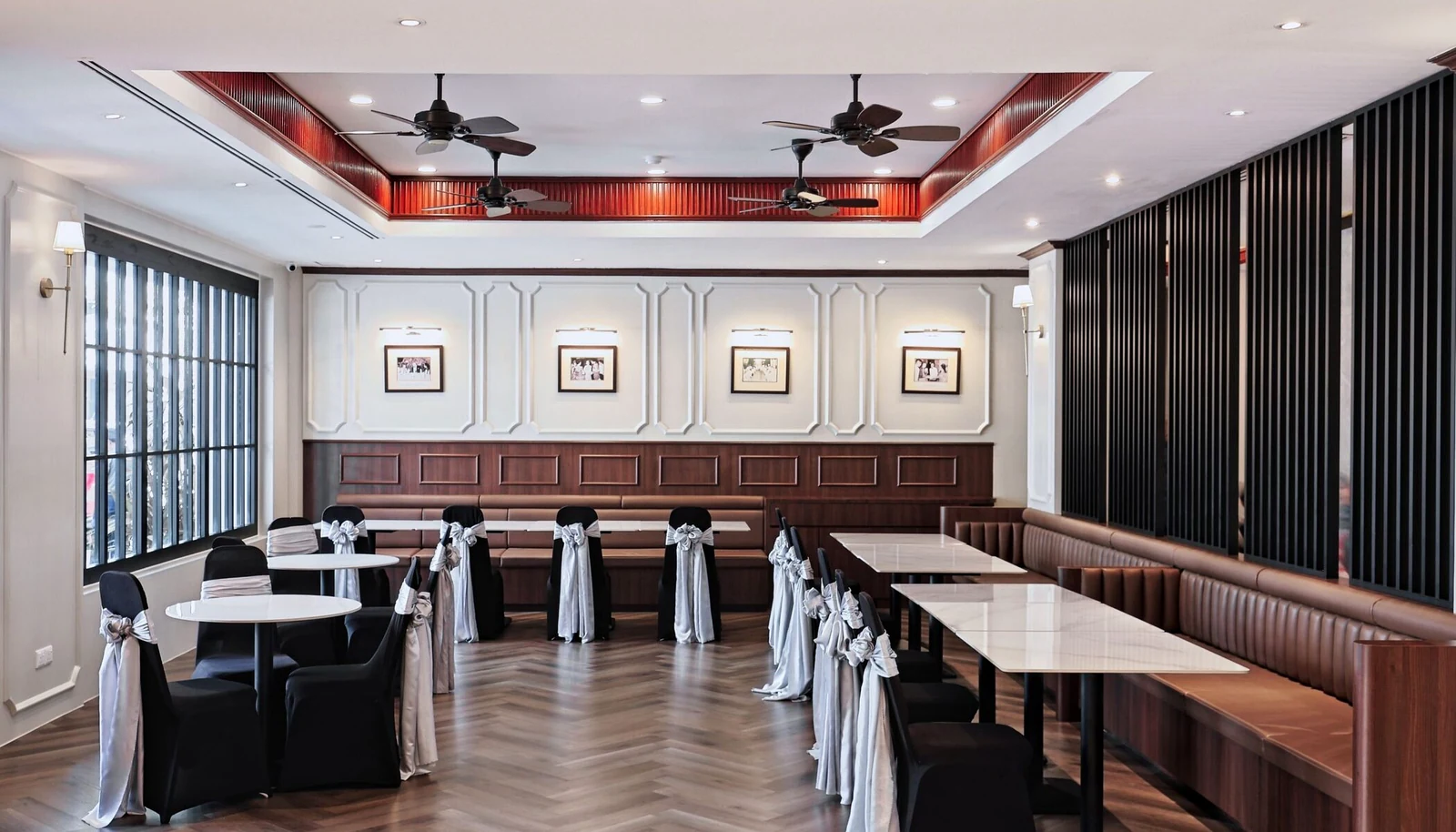 Heritage lounge of The Jesselton Hotel with framed archival black-and-white photographs of colonial-era Jesselton